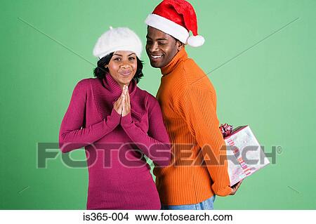 Man surprising woman with gift View Large Photo Image Picture - Man surprising woman with gift. Fotosearch