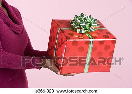 Woman holding present View Large Photo Image Stock Image - Woman holding present. Fotosearch