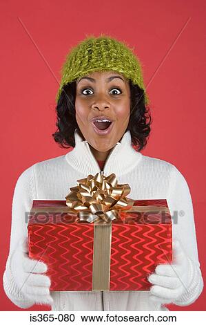 Woman holding present View Large Photo Image Stock Image - Woman holding present. Fotosearch