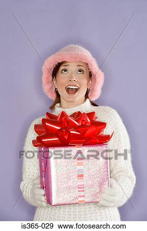Stock Photo - Woman holding present. Fotosearch