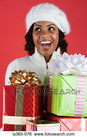 Woman holding presents View Large Photo Image Stock Photograph - Woman holding presents. Fotosearch