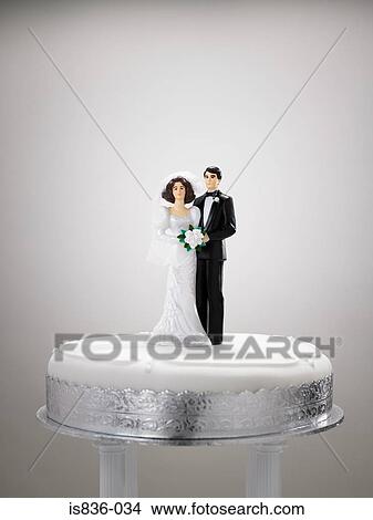 Bride and bridegroom figurines on a wedding cake View Large Photo Image Picture - Bride and bridegroom figurines on a wedding cake. Fotosearch