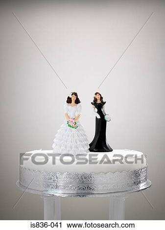 Stock Image - Bride and bridesmaid figurine on a wedding cake. Fotosearch