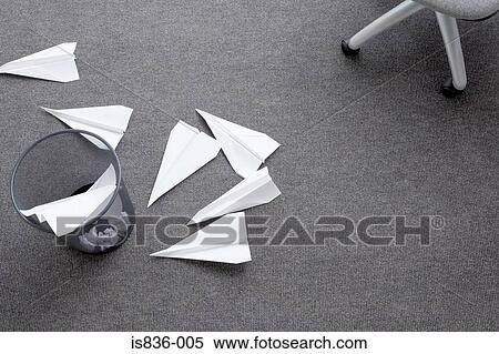 Stock Photography - Paper aeroplanes a bin and a chair. Fotosearch