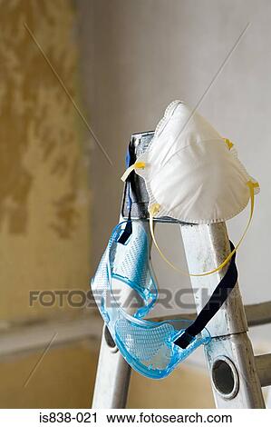 Stock Image - Dust mask and goggles on a stepladder. Fotosearch