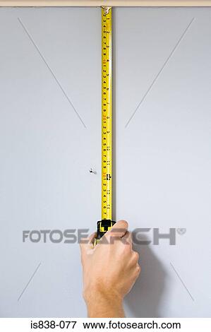 Person measuring wall View Large Photo Image Stock Photo - Person measuring wall. Fotosearch