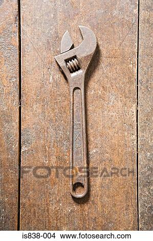 Picture - Wrench on a wooden floor. Fotosearch