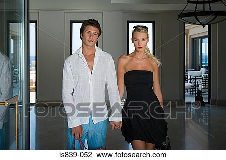 Couple holding hands in hotel lobby View Large Photo Image Stock Image - Couple holding hands in hotel lobby. Fotosearch