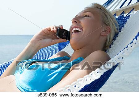 Woman on hammock with cellphone View Large Photo Image Stock Photography - Woman on hammock with cellphone. Fotosearch