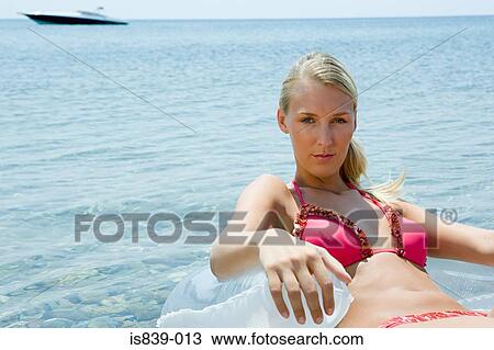 Stock Image - Young woman in the sea. Fotosearch