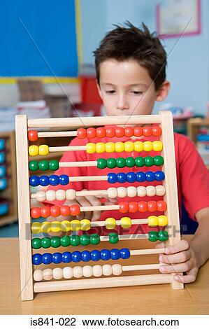 Boy counting on an abacus View Large Photo Image Stock Image - Boy counting on an abacus. Fotosearch