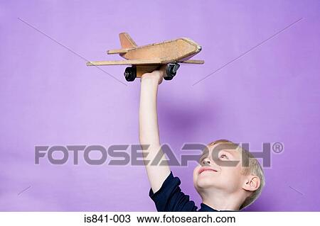 Boy playing with aeroplane View Large Photo Image Stock Image - Boy playing with aeroplane. Fotosearch