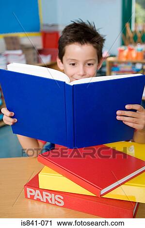 Stock Image - Boy reading a book. Fotosearch