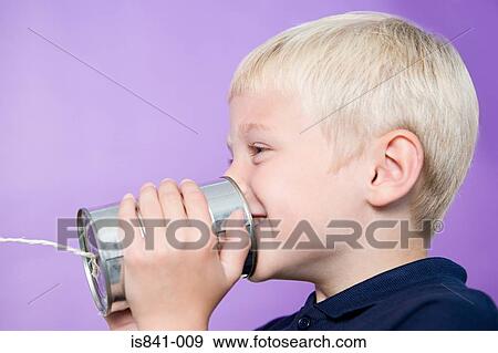 Boy talking on a tin can telephone View Large Photo Image Stock Photo - Boy talking on a tin can telephone. Fotosearch