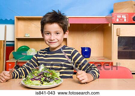 Boy with a plate of salad View Large Photo Image Stock Image - Boy with a plate of salad. Fotosearch
