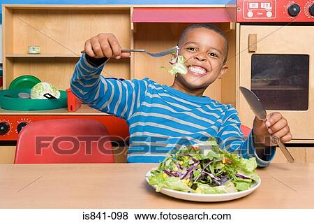 Boy with a plate of salad View Large Photo Image Stock Photo - Boy with a plate of salad. Fotosearch