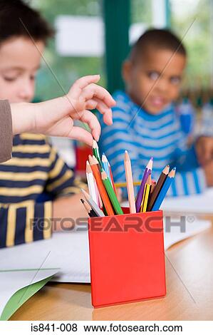 Child choosing coloured pencil View Large Photo Image Stock Photo - Child choosing coloured pencil. Fotosearch