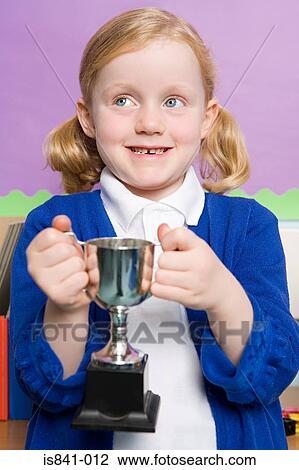 Stock Image - Girl holding trophy. Fotosearch