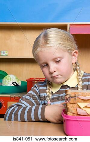 Girl looking at lunch box View Large Photo Image Stock Image - Girl looking at lunch box. Fotosearch