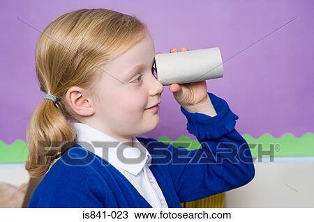 Stock Image - Girl looking through toilet roll. Fotosearch