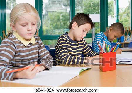 Primary school students writing View Large Photo Image Picture - Primary school students writing. Fotosearch