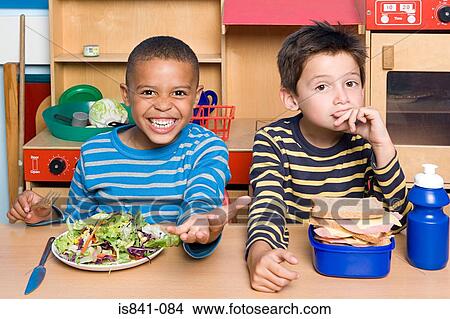 Two boys having their lunch View Large Photo Image Picture - Two boys having their lunch. Fotosearch