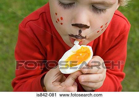 Boy eating an egg View Large Photo Image Stock Image - Boy eating an egg. Fotosearch