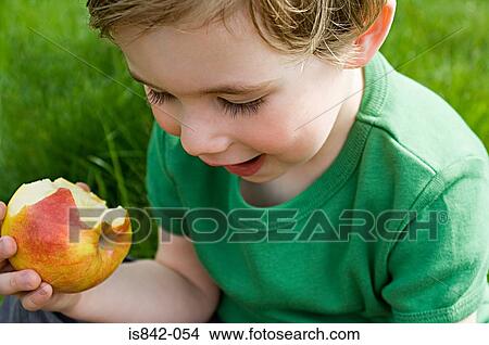Boy eating apple View Large Photo Image Picture - Boy eating apple. Fotosearch