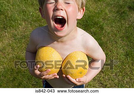 Boy holding melon halves View Large Photo Image Stock Image - Boy holding melon halves. Fotosearch