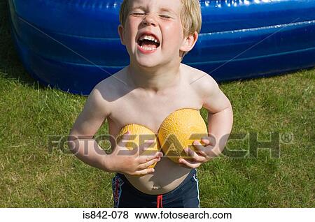 Boy holding melon halves View Large Photo Image Stock Photo - Boy holding melon halves. Fotosearch