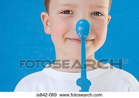 Boy with spoon on his nose View Large Photo Image Stock Photo - Boy with spoon on his nose. Fotosearch