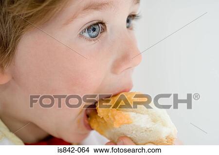 Child eating piece of bread View Large Photo Image Picture - Child eating piece of bread. Fotosearch