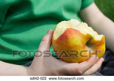 Stock Image - Child with an eaten apple. Fotosearch