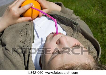 Girl drinking orange View Large Photo Image Stock Image - Girl drinking orange. Fotosearch