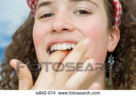 Girl eating tomato sauce View Large Photo Image Picture - Girl eating tomato sauce. Fotosearch