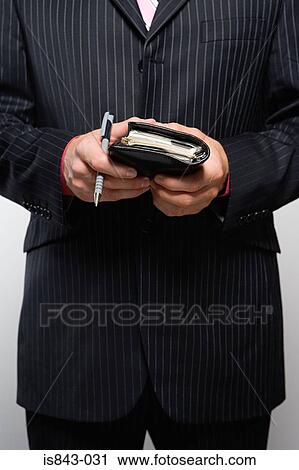 Businessman holding diary View Large Photo Image Stock Image - Businessman holding diary. Fotosearch