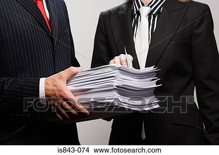 Businessman holding paperwork View Large Photo Image Picture - Businessman holding paperwork. Fotosearch