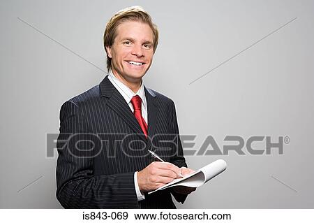 Businessman writing in notebook View Large Photo Image Stock Photo - Businessman writing in notebook. Fotosearch