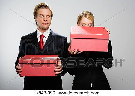 Businesspeople holding boxes View Large Photo Image Stock Image - Businesspeople holding boxes. Fotosearch