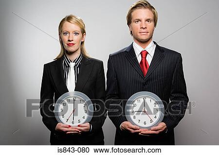 Businesspeople holding clocks View Large Photo Image Stock Image - Businesspeople holding clocks. Fotosearch