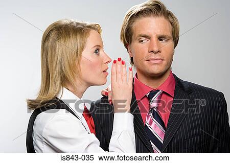 Businesswoman whispering to colleague View Large Photo Image Stock Photography - Businesswoman whispering to colleague. Fotosearch