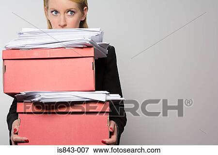 Stock Photo - Woman holding stack of paperwork. Fotosearch