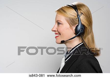 Woman wearing a telephone headset View Large Photo Image Stock Image - Woman wearing a telephone headset. Fotosearch