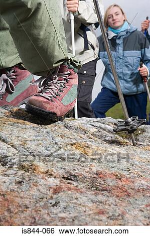Stock Photograph - Hikers walking on rocks. Fotosearch