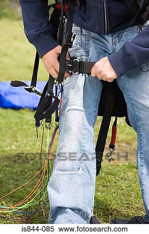 Stock Photography - Male parachutist adjusting his equipment. Fotosearch