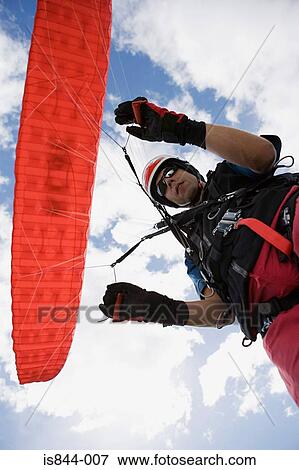 Male parachutist with red parachute View Large Photo Image Stock Photo - Male parachutist with red parachute. Fotosearch