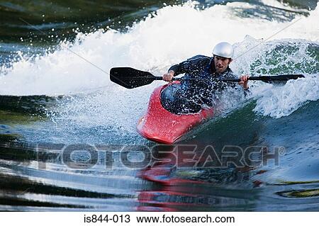 Stock Image - Man kayaking on river. Fotosearch