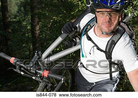Mountain biker carrying bike View Large Photo Image Stock Photo - Mountain biker carrying bike. Fotosearch