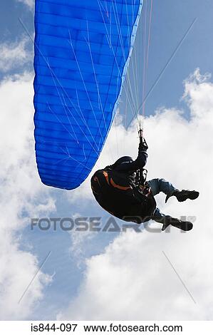 Person with a blue parachute View Large Photo Image Stock Photo - Person with a blue parachute. Fotosearch