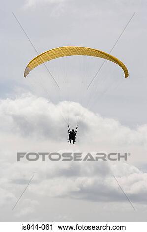 Person with a yellow parachute View Large Photo Image Stock Image - Person with a yellow parachute. Fotosearch